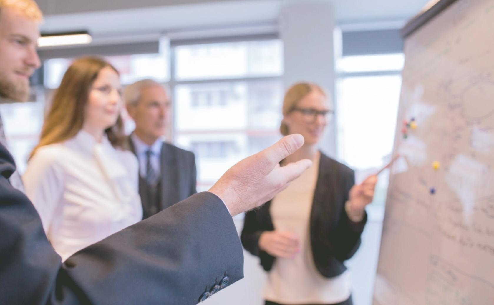 Professional financial consultation meeting with family business owners discussing growth strategies and investment planning